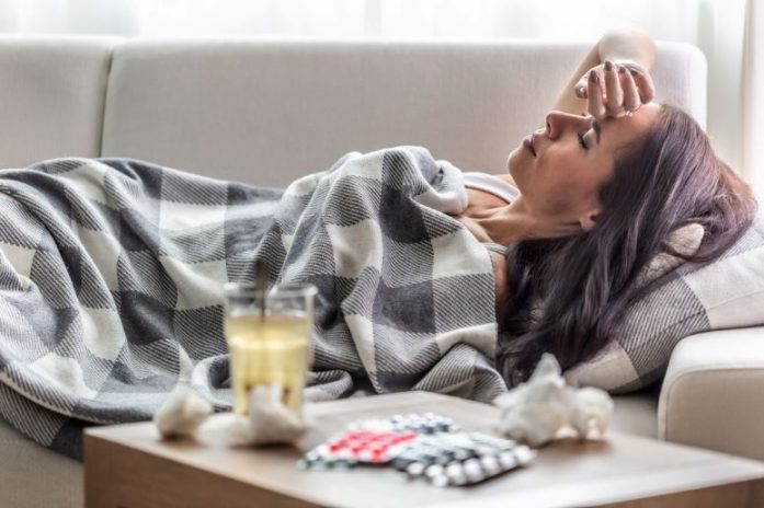 Sick woman lying on couch