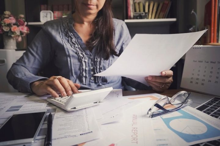 Budget planning concept,Accountant is calculating company's annual tax.Calendar 2020 and personal income tax forms for those who have income under US law placed on office desk.
